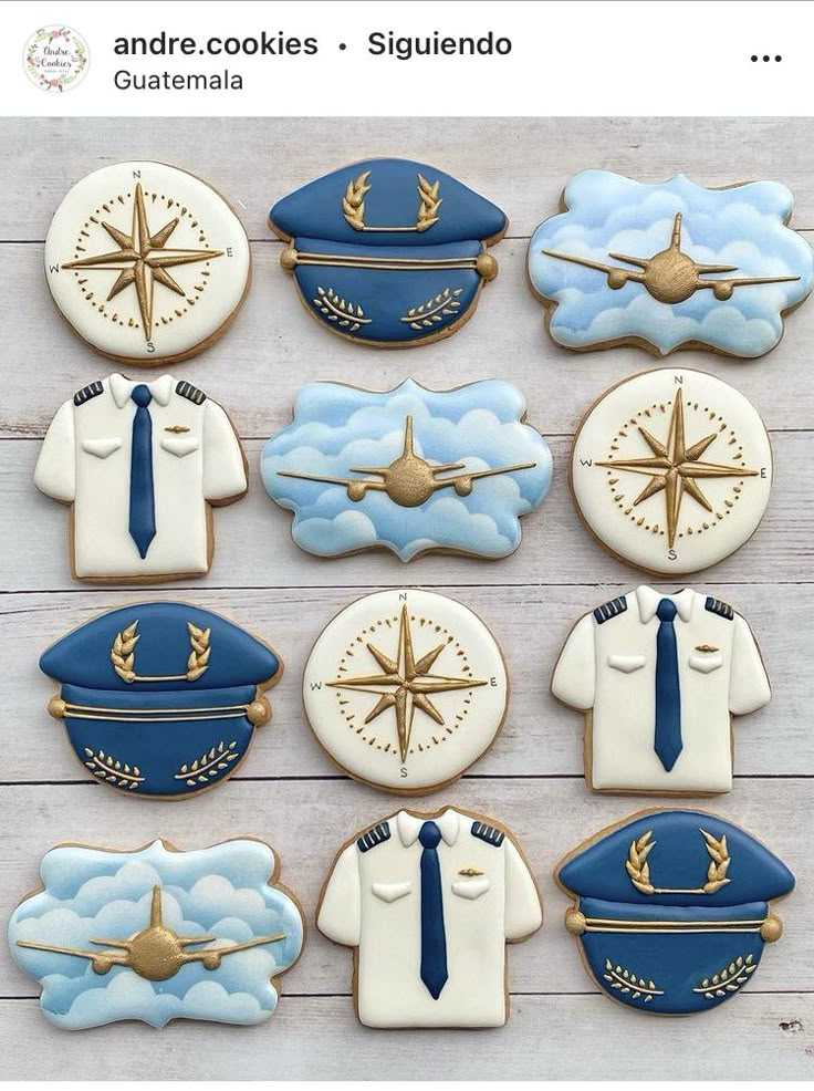 cookies decorated with blue and white uniforms are arranged on a wooden surface, including one pilot's uniform