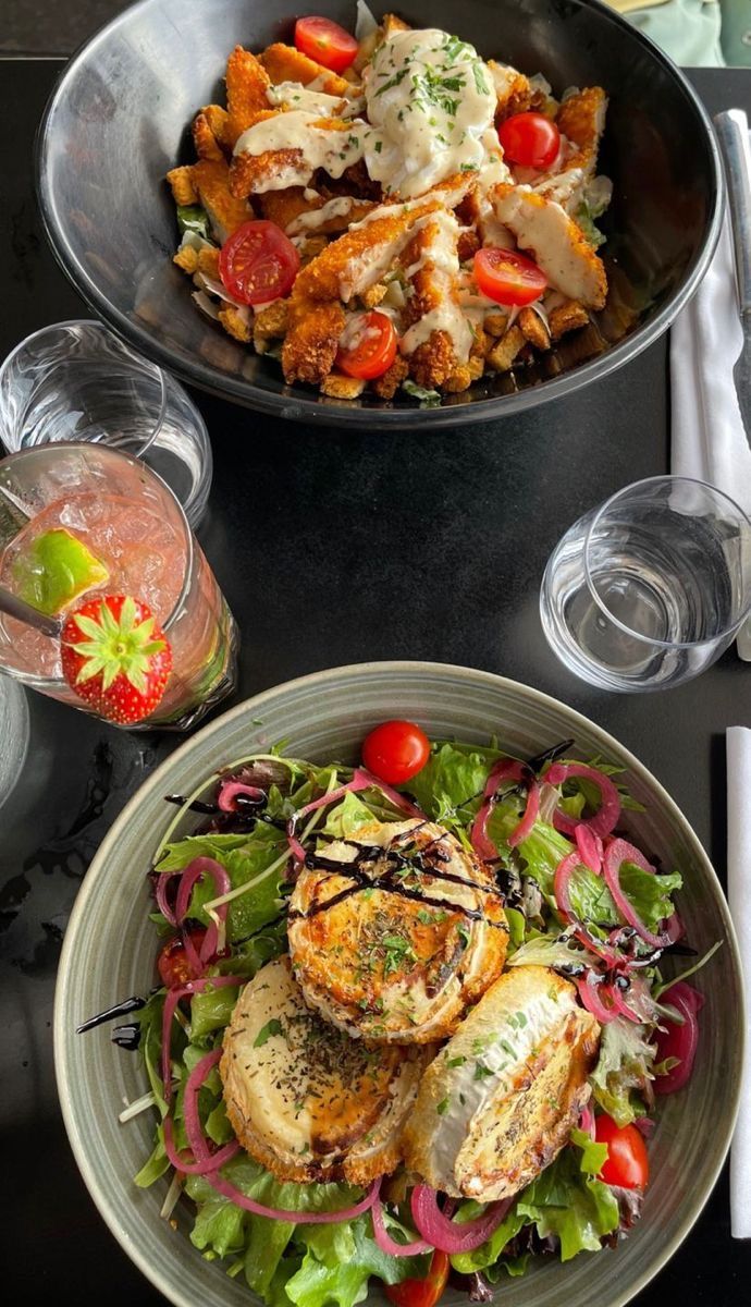 two plates filled with food on top of a table