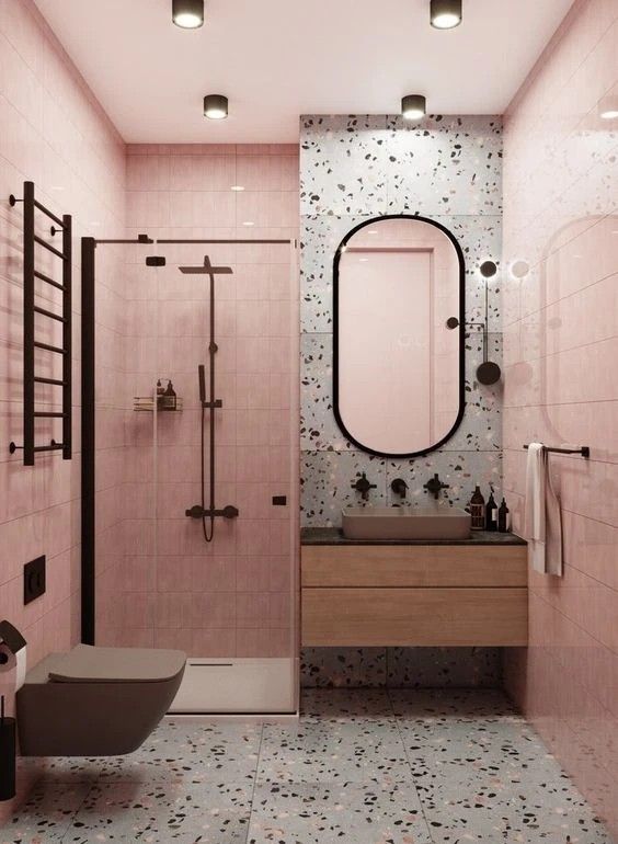 a bathroom with pink walls and floor tiles