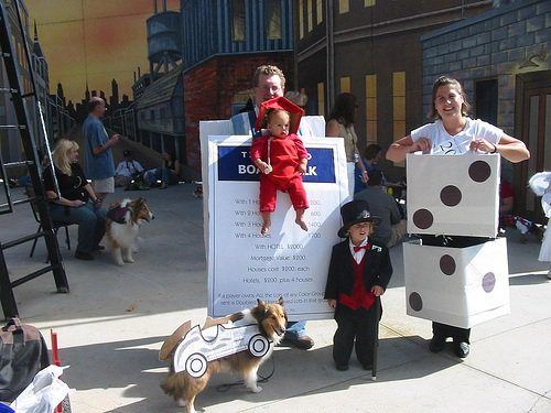 three children and two adults are posing for a photo in front of some cardboard boxes