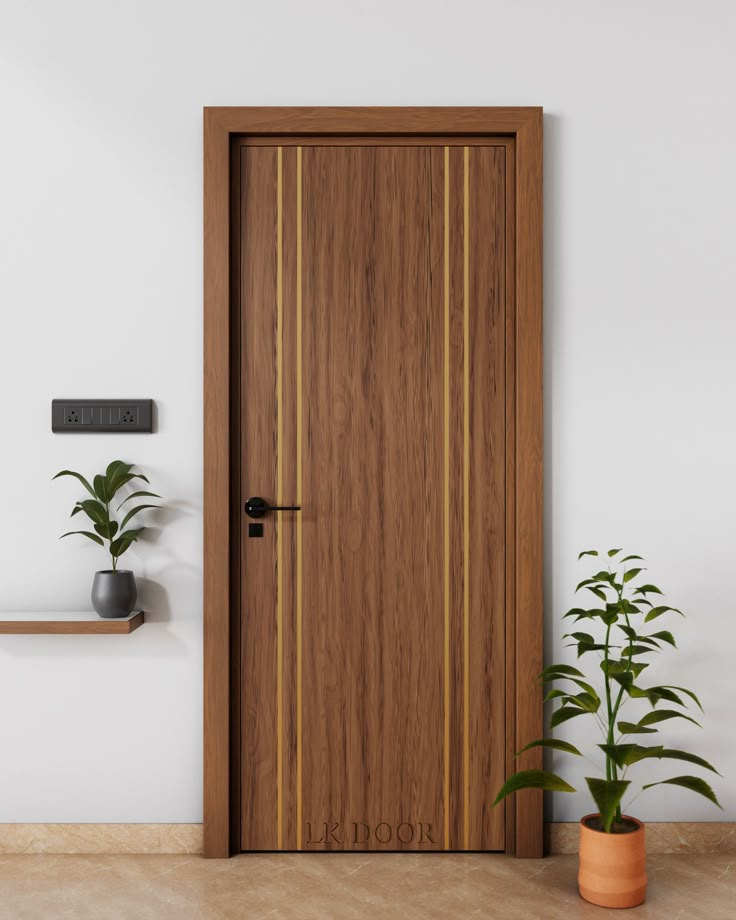 a wooden door in an empty room with potted plants