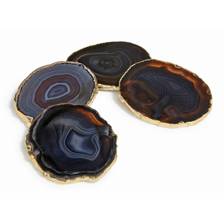 three agate stone coasters with gold trimming and black veining on them