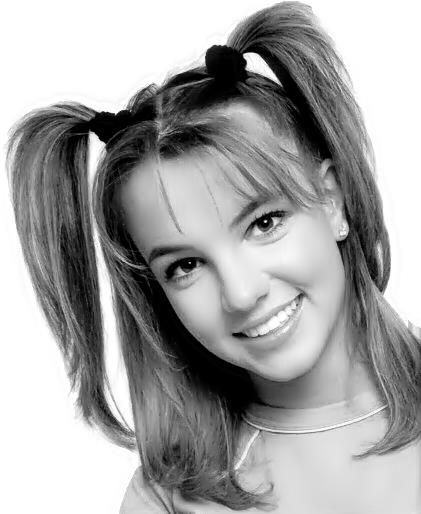 a black and white photo of a woman with two ponytails on her head, smiling