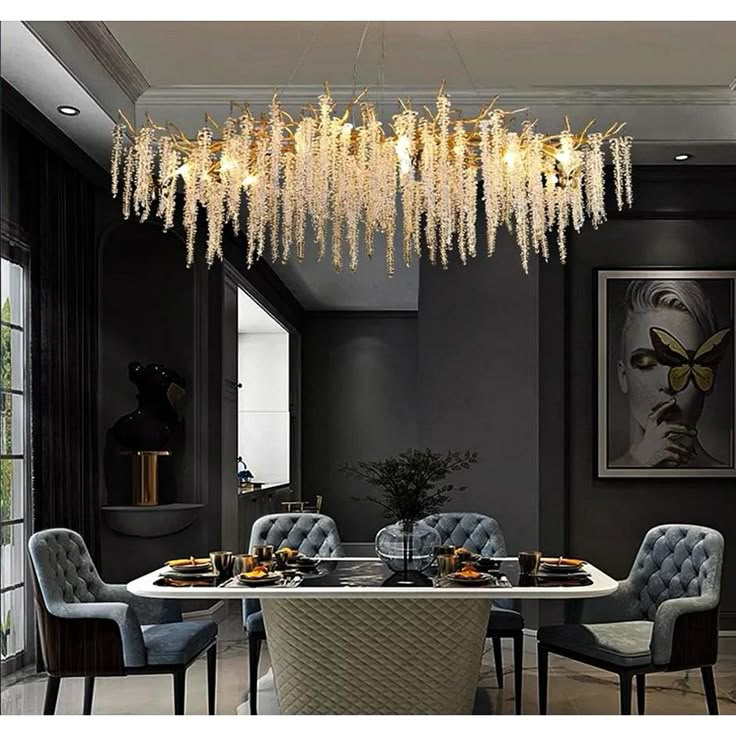 a chandelier hanging from the ceiling in a dining room with chairs around it