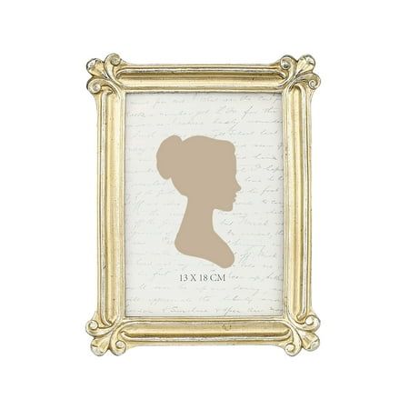 the silhouette of a woman's head in a gold frame