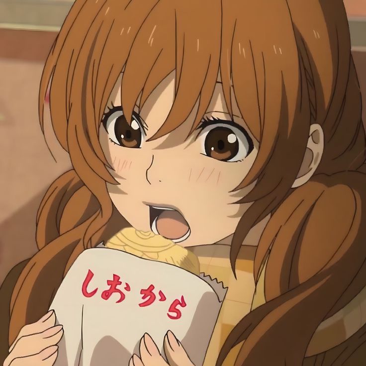 an anime character with long hair and brown eyes holding a book in front of her face