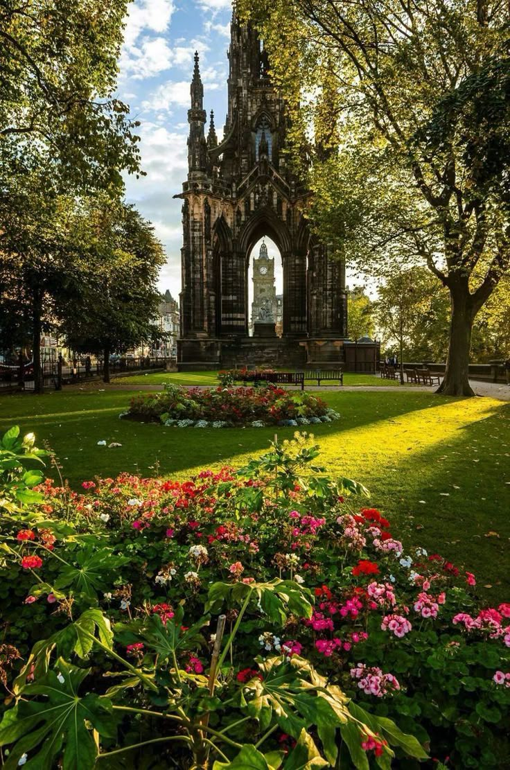 an old building surrounded by flowers and trees