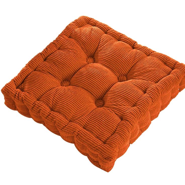 an orange square cushion on a white background