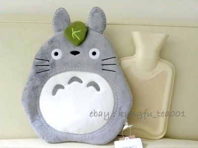 a totoro stuffed animal sitting on top of a shelf