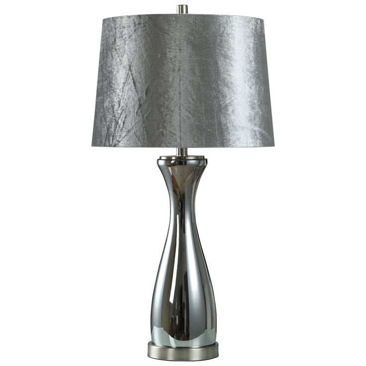 a table lamp with a silver shade on it's base and a white background