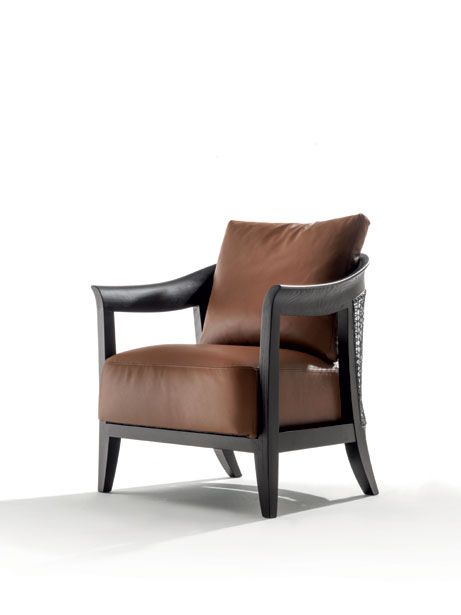 a brown leather chair sitting on top of a white floor next to a black frame