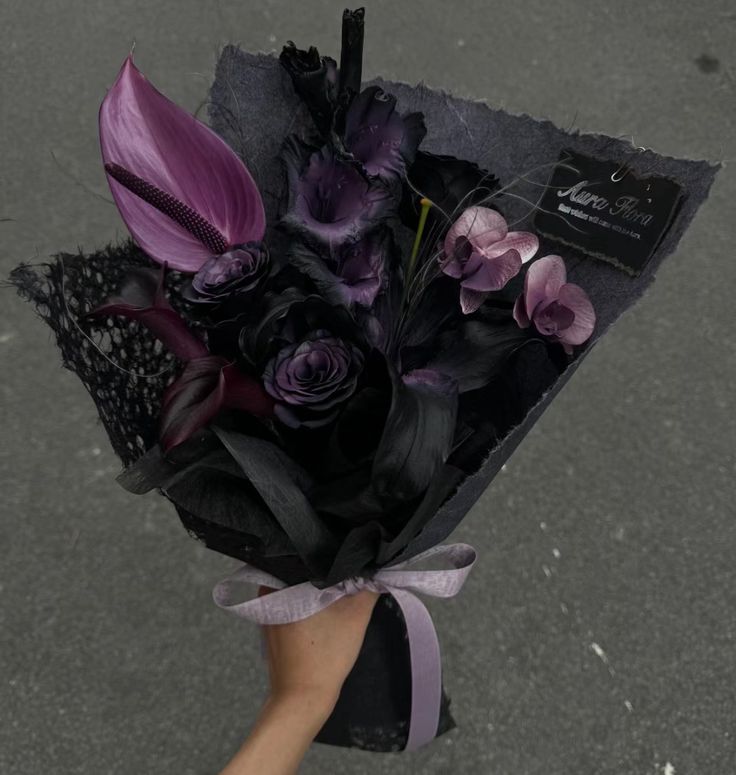 a person holding a bouquet of flowers in their hand