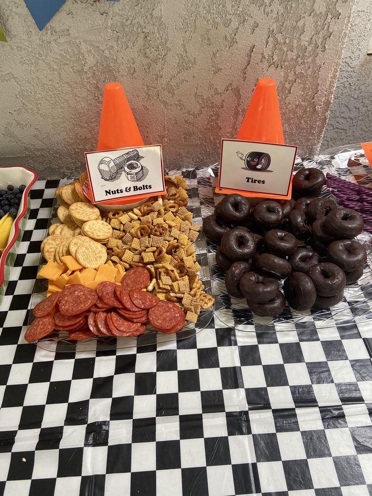 a table topped with lots of different types of food and cones on top of it