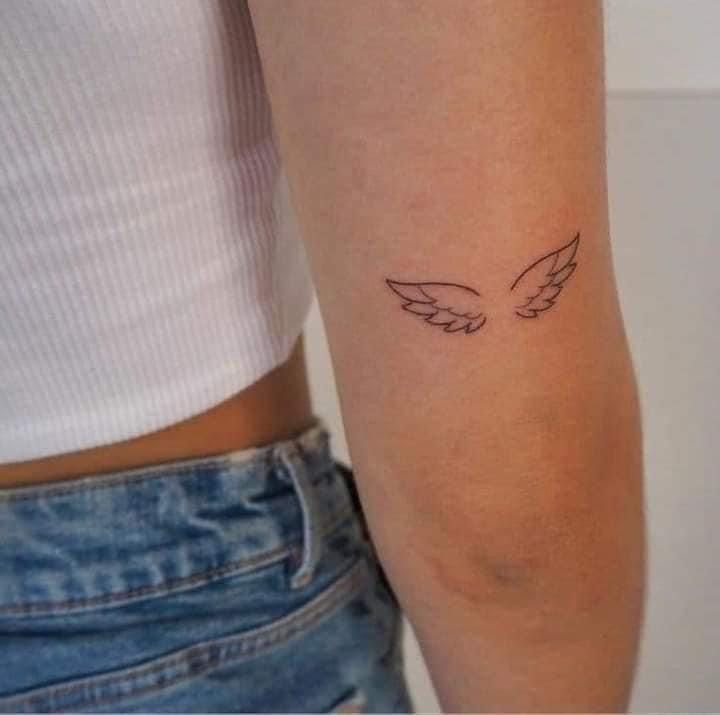 a woman with a small tattoo on her arm