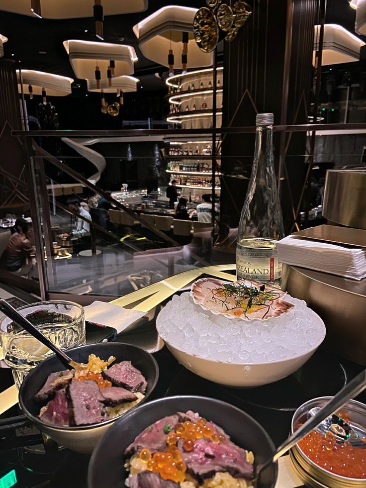 a table topped with lots of different types of food next to a bottle of wine