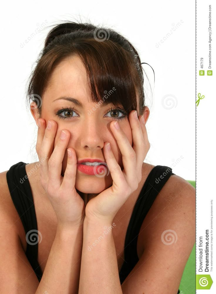 a woman is posing with her hands on her face and looking at the camera while wearing black