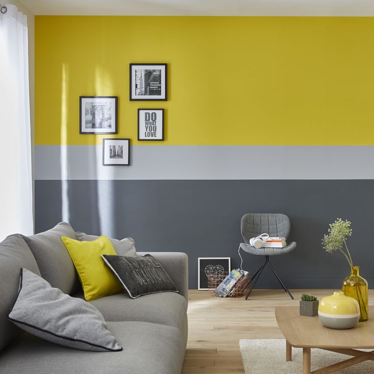 a living room with yellow and gray walls