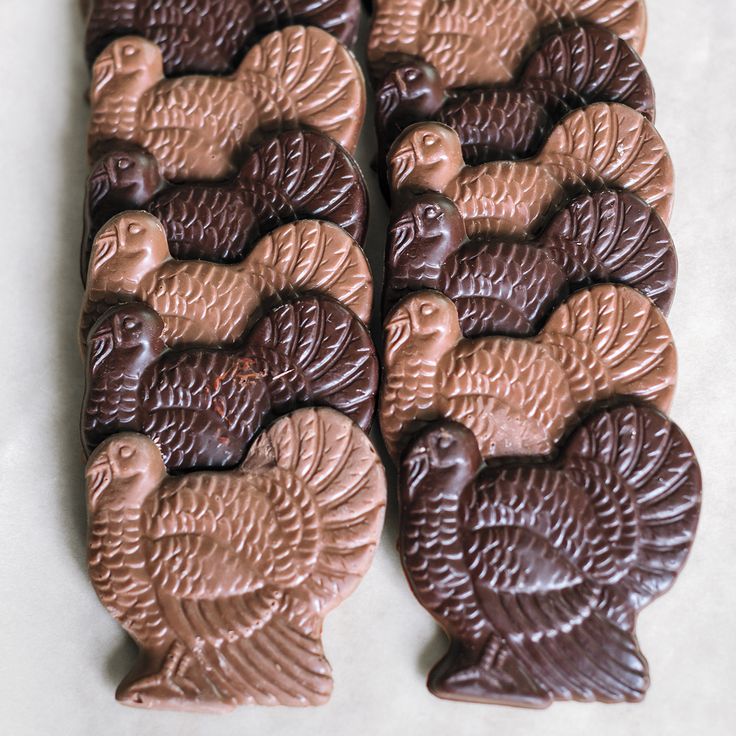 chocolate turkeys are arranged in rows on a table