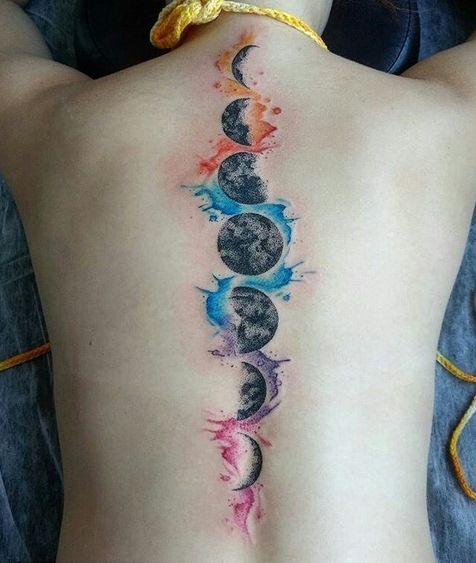 a woman's back with the moon and stars painted on it