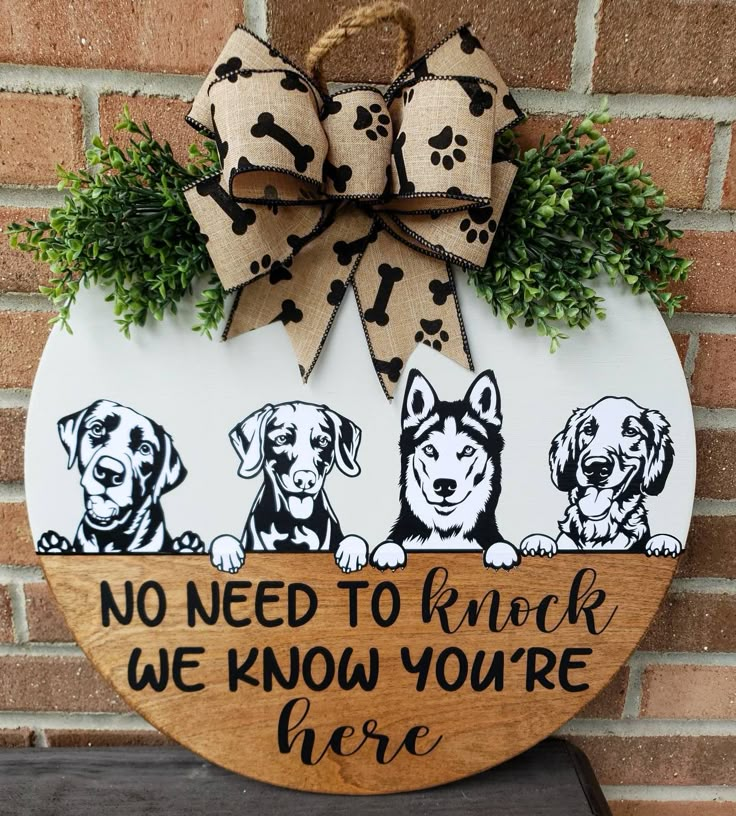 a wooden sign with three dogs on it that says, no need to knock we know you're here