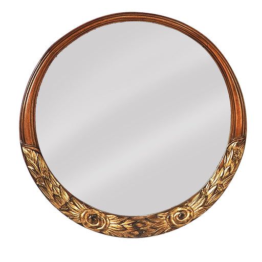 a round mirror with an ornate design on it