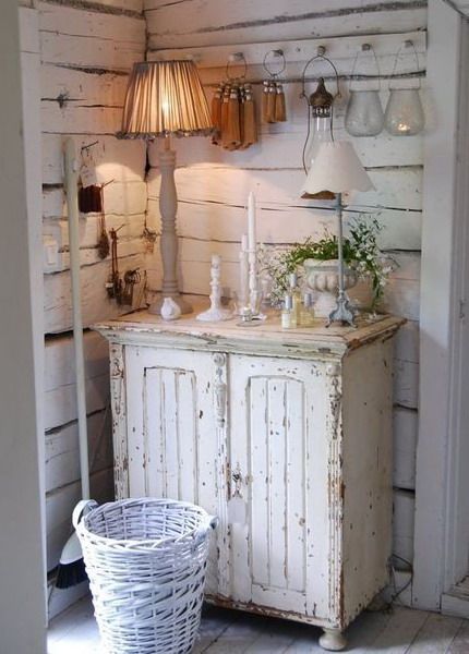 an old white cabinet with some lights on it and other items in front of it