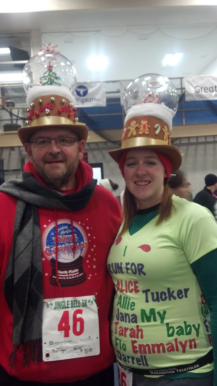 a man and woman wearing funny hats at an event