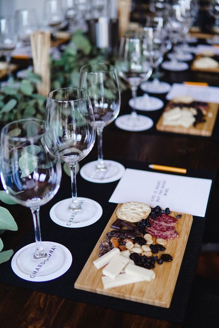 several wine glasses and cheese plates on a table