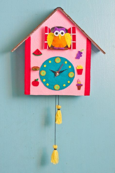 a clock made to look like a house with an owl on the front and sides