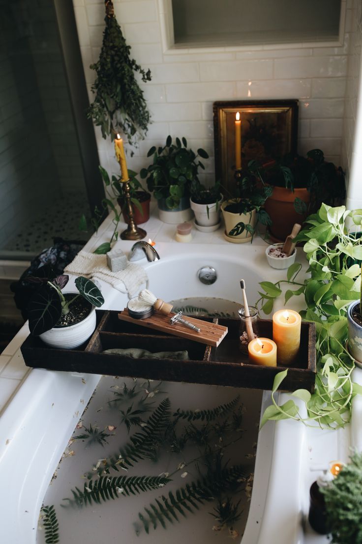 A dreamy bath surrounded by green plants. A wooden board crosses the tub filled with candles, more plants, a butterfly safety razor, and a shaving brush. The photo is moody, dark, and dreamy. Bath Aesthetic, Beeswax Pillar Candles, Spiritual Bath, Dream Bath, Relaxing Bath, Dream Apartment, Dream Bathroom, Dream House Decor, House Inspo