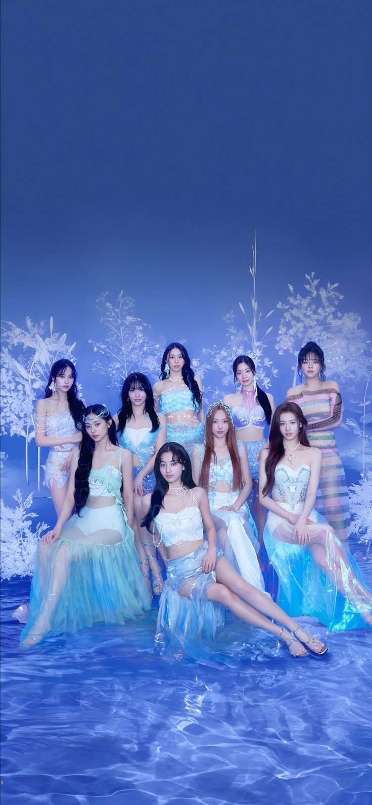 a group of women are posing for a photo in the water with snowflakes behind them