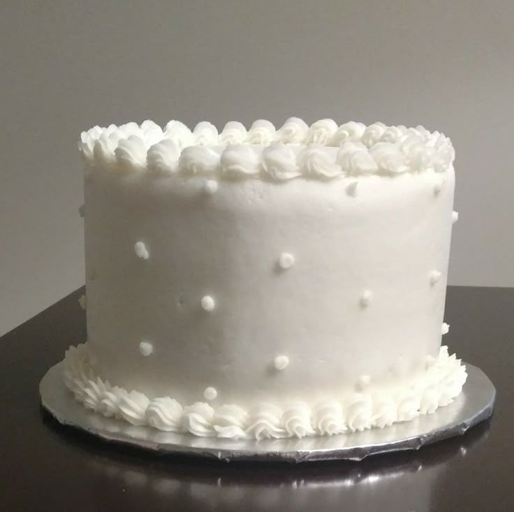 a close up of a white cake on a table