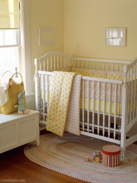 a white crib in a yellow nursery