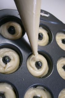 an image of donuts being made in a muffin tin with icing on them