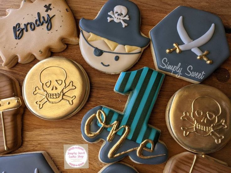 decorated cookies are arranged on a wooden table