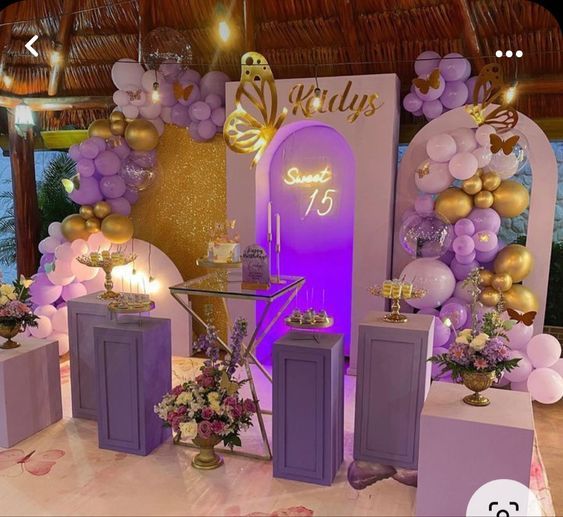 a purple and gold birthday party with balloons