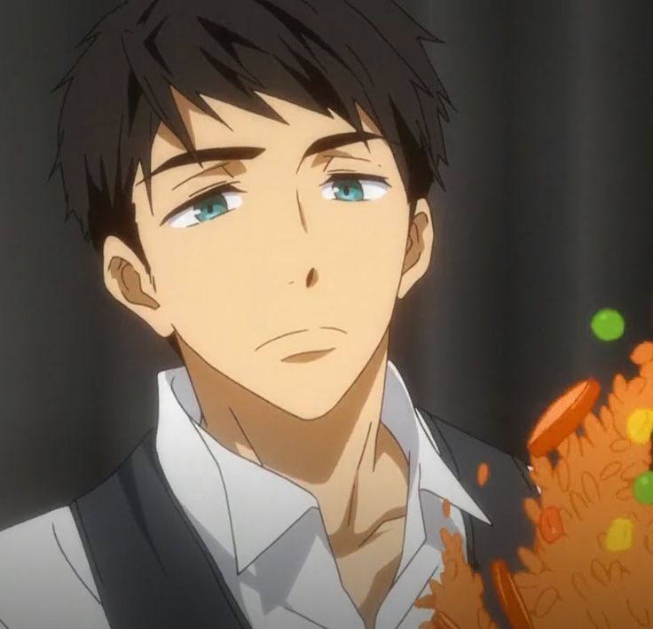 an anime character with black hair and blue eyes looking at something orange in front of him