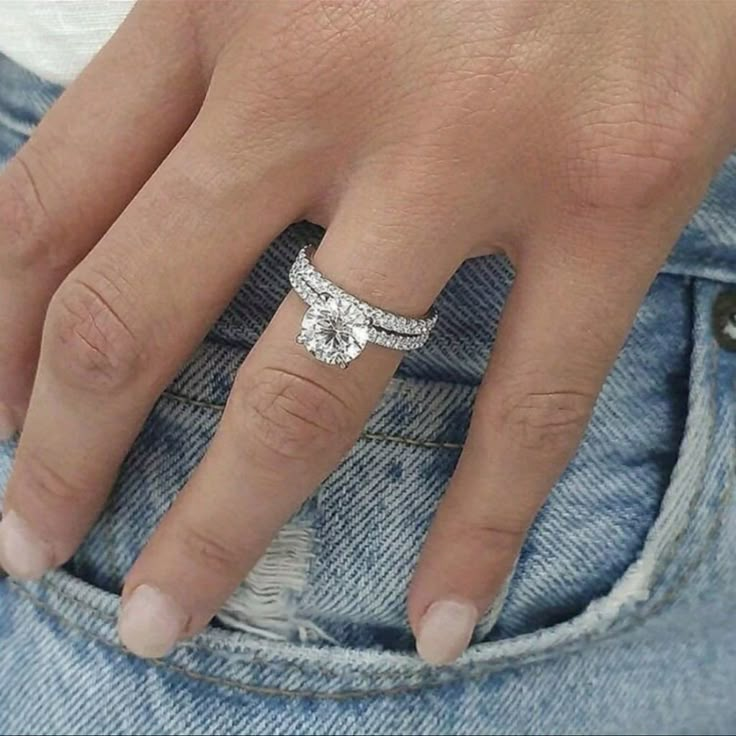 a close up of a person's hand with a ring on it