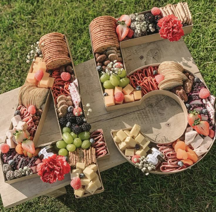 a number made out of different types of food on top of green grass with flowers