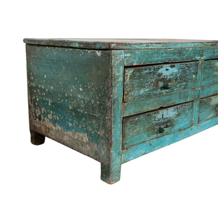 an old wooden dresser with peeling paint on the top and bottom drawers, against a white background