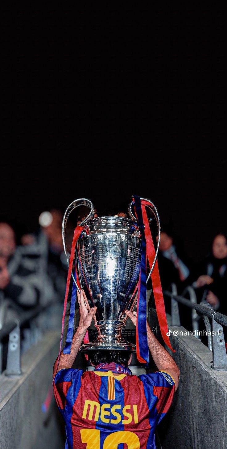 the messi trophy is held up in front of an audience