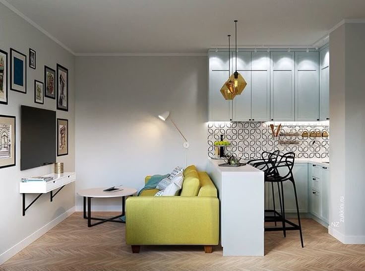 a living room filled with furniture next to a kitchen