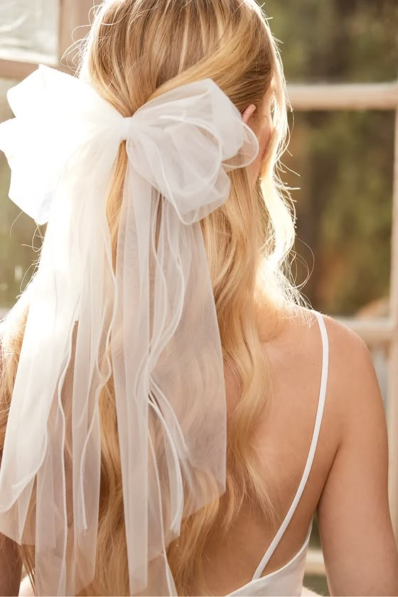 the back of a woman's head wearing a white veil