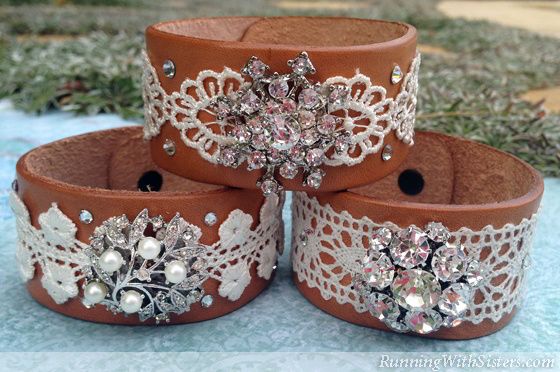 four brown leather bracelets with white lace and crystal stones on each one, sitting in the grass