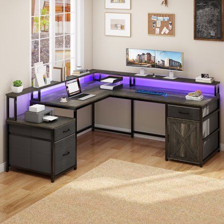 an office desk with purple lighting in the corner and two drawers on each side, next to a window