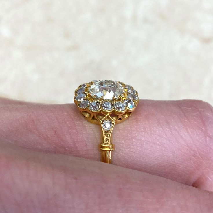 a close up of a person's hand with a gold ring on top of it