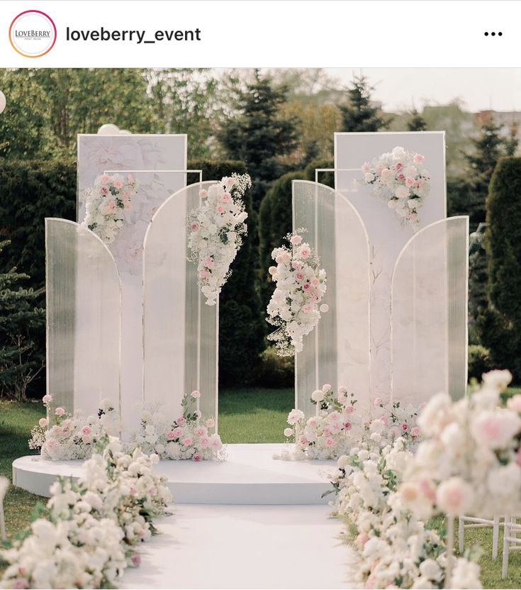 an outdoor ceremony setup with white and pink flowers