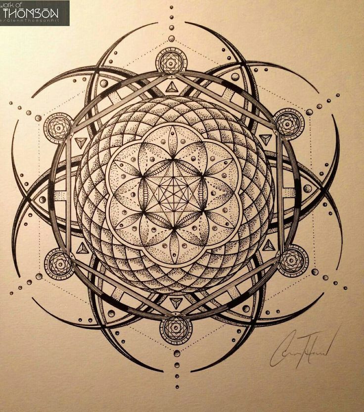 a pen drawing on paper with an intricate design in the center and circles around it