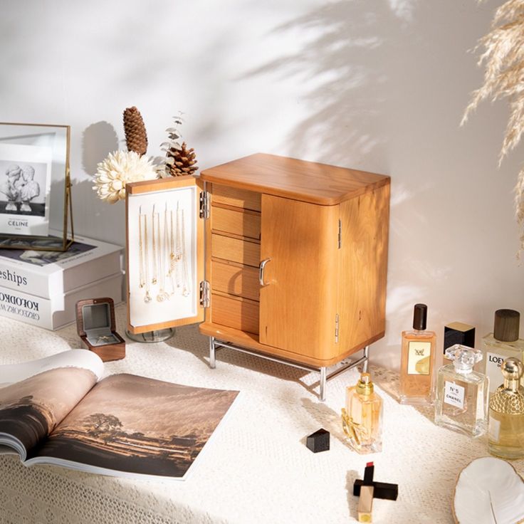 an open book sitting on top of a table next to a cabinet and other items