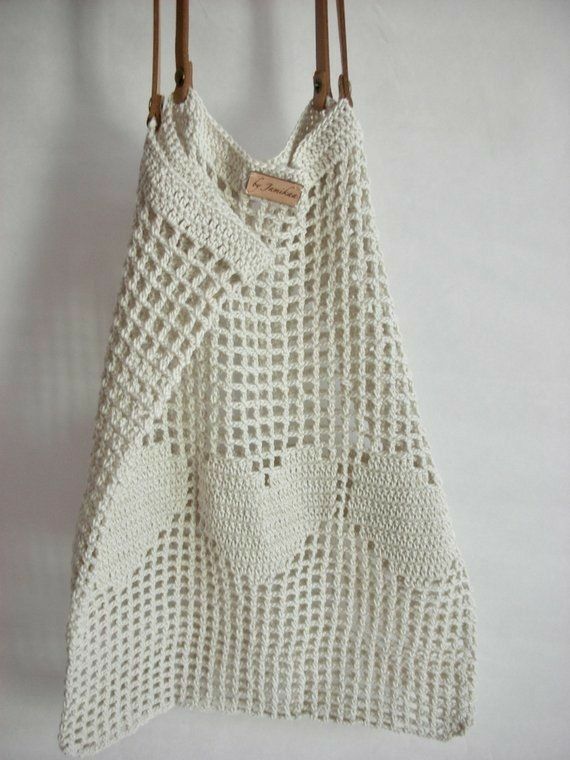 a white crocheted bag hanging from a hook